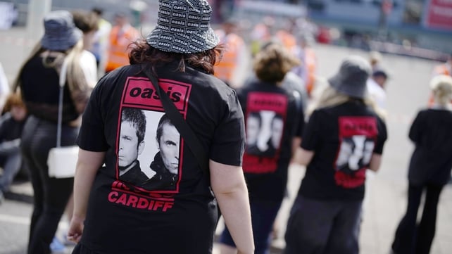 Oasis fans wearing band t-shirts outside the Principality Stadium, Cardiff