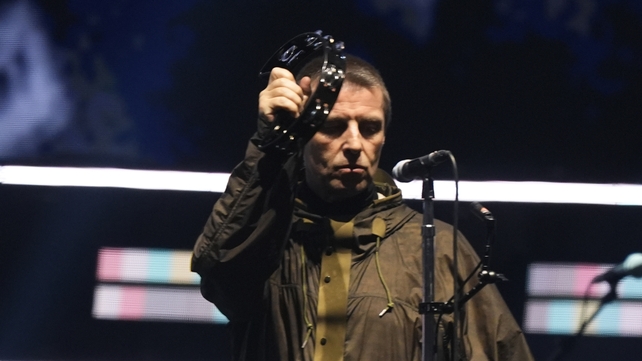 Liam Gallagher holding up a tambourine