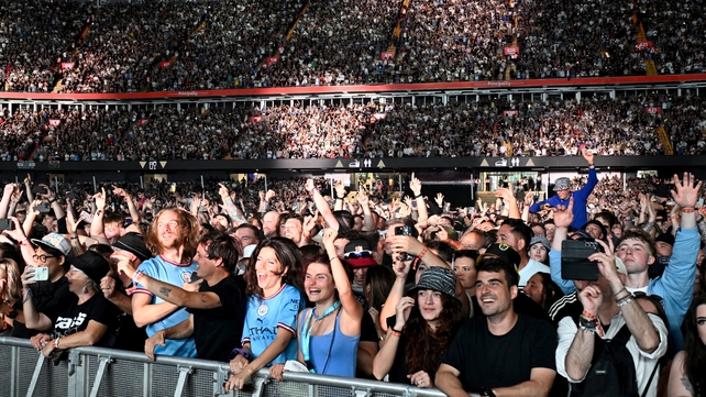 CARDIFF, WALES - JULY 04: (EDITORS NOTE: EDITORIAL USE ONLY. IMAGES MAY ONLY BE USED IN RELATION TO THE EVENT. NO COMMERCIAL USE. NO USE IN PUBLICATIONS SOLELY DEDICATED TO THE ARTIST. NO USE AFTER JULY 03, 2026.) Fan wait for Oasis to perform on stage du