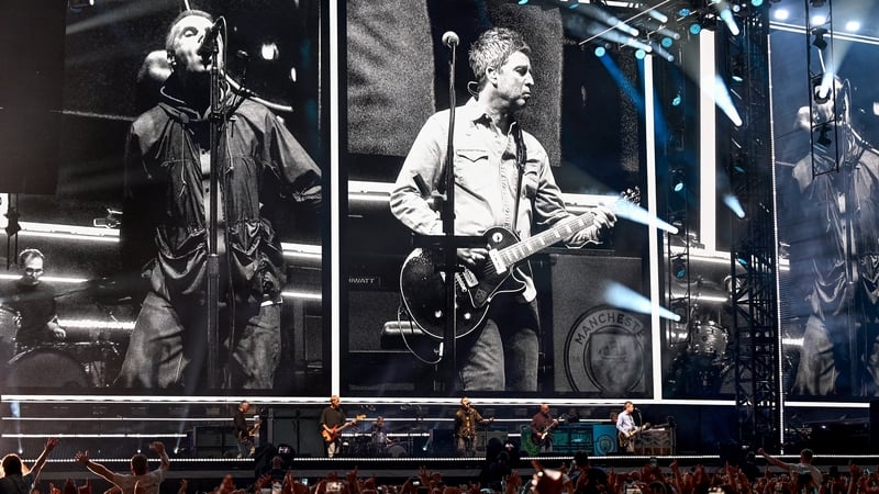 Liam and Noel Gallagher of Oasis on stage at the opening night of their reunion tour in Principality Stadium in Cardiff on 4 July
