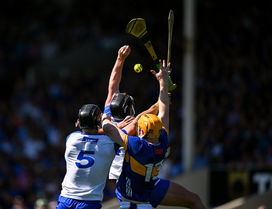 The sliotar drops between Waterford's Iarlaith Daly and Mark Fitzgerald, left, and Tipperary's Jake Morris
