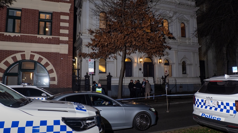 Police officers are seen collecting evidence at the synagogue which was the scene of an arson attack