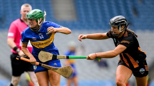 Casey Hennessy of Tipperary is tackled by Tiffanie Fitzgerald
