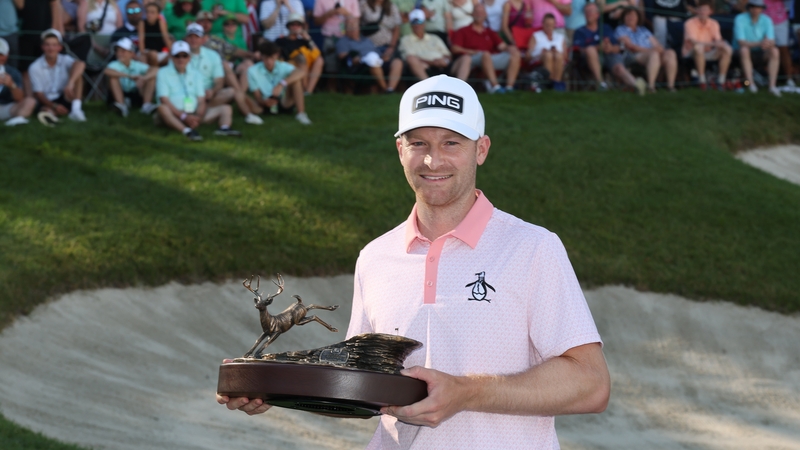 Brian Campbell celebrates with the trophy after winning the John Deere Classic