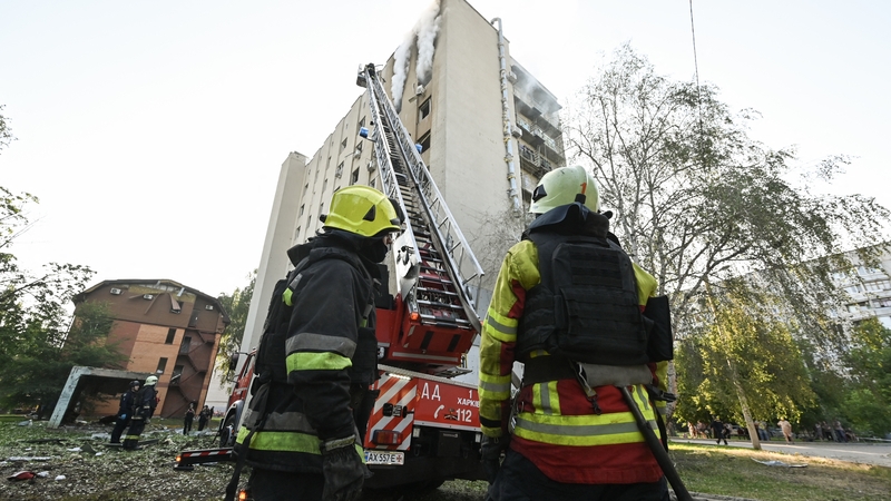 Firefighters extinguish a fire in a residential building following a Russian drone strike in Kharkiv, Ukraine