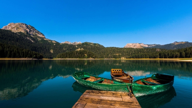 boats on a lake with a dock