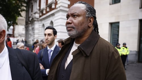 Reginald D Hunter leaves Westminster Magistrates' Court in London on Monday. He was bailed to return for a hearing at the same court on 14 November