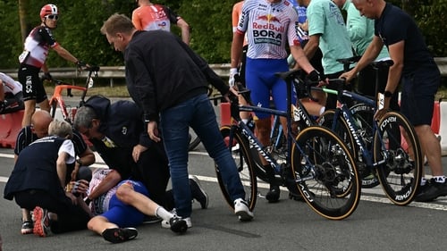 Red Bull Bora-Hansgrohe's Jordi Meeus receives medical assistance after being involved in a crash in the final kilometre of the stage