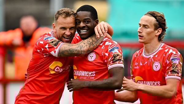 Mipo Odubeko of Shelbourne, centre, celebrates with Paddy Barrett, left, and Harry Wood, right, after scoring their side's second goal during the SSE Airtricity Men's Premier Division match between Shelbourne and Cork City at Tolka Park in Dublin.