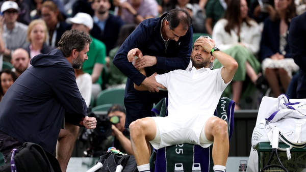 LONDON, ENGLAND - JULY 07: Grigor Dimitrov of Bulgaria reacts as he receives medical attention against Jannik Sinner of Italy during the Gentlemen's Singles fourth round match on day eight of The Championships Wimbledon 2025 at All England Lawn Tennis and