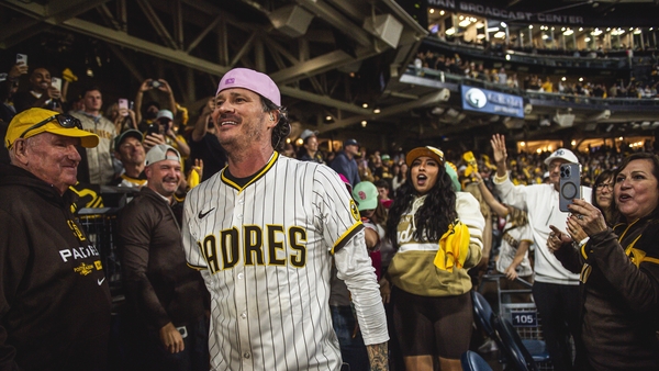 SAN DIEGO, CALIFORNIA - OCTOBER 8: Blink-182's Tom DeLonge sings while walking through the crowd during game three of the National League Divisional Series as the San DIego Padres face against the Los Angeles Dodgers at Petco Park on October 8, 2024, in S