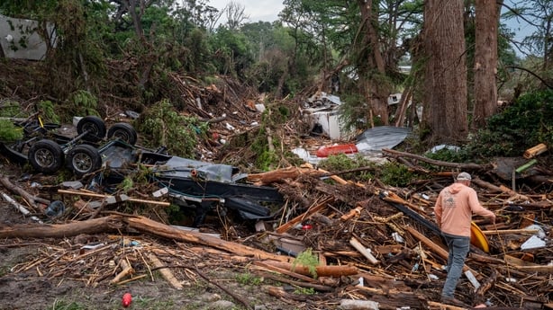 CENTER POINT, TEXAS - JULY 06: Sergio Sanchez walks through debris while assisting with search and rescue efforts on the banks of the Guadalupe River on July 06, 2025 in Center Point, Texas. Sanchez and his family drove from San Antonio to help with search and rescue efforts. Heavy rainfall caused s