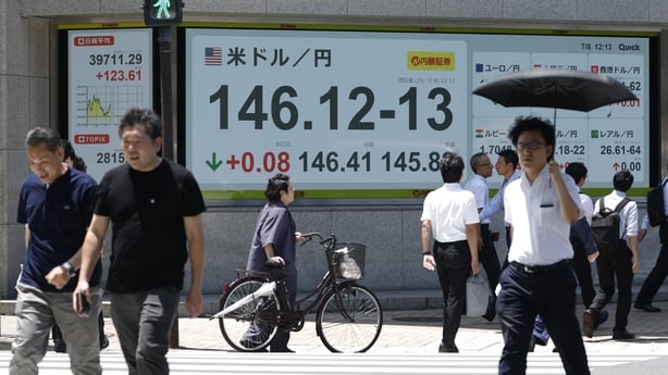 The rate of the yen against the US dollar, center, displayed outside a securities firm in Tokyo, Japan, on Tuesday, July 8, 2025. Asian shares edged higher after President Donald Trump suggested that he was still open to additional negotiations after imposing new tariff rates on partners including J