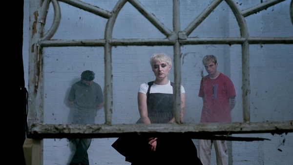 a person in a white dress behind a window