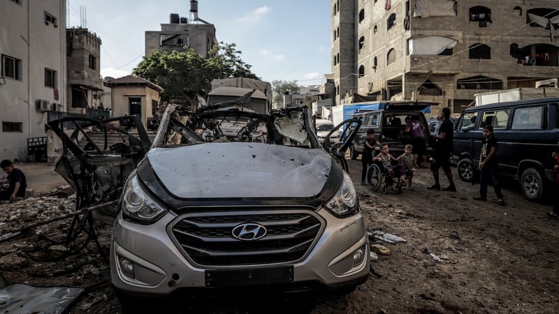 Palestinian children inspect a destroyed vehicle after an Israeli attack in Gaza City, Gaza