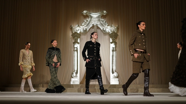 a group of women walking on a stage