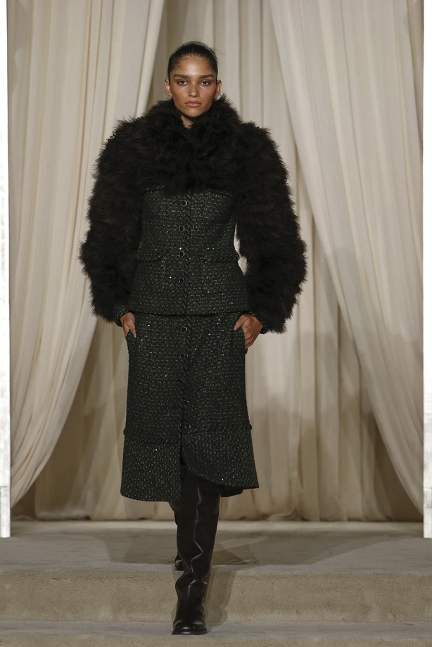 a person in a black jacket and skirt
