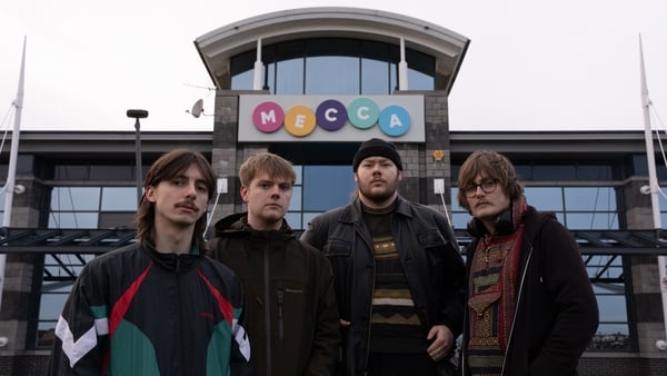 a group of men standing in front of a building