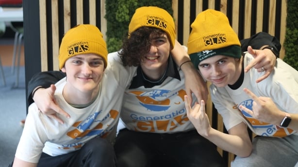 Three young people posing for a picture wearing hats and t shirts from Generation Glas