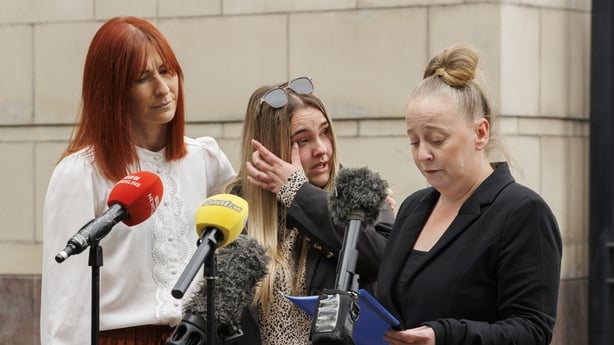 Paul Rowlands' sister Cheryl Burns accompanied by her niece Leanne Rowlands (centre) and Detective Inspector Claire McGarvey (left) outside Belfast Crown Court standing next to microphones 