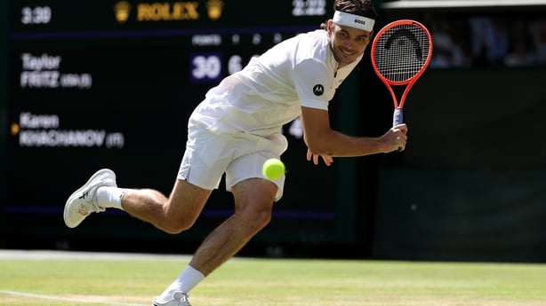 Taylor Fritz of United States reaches to play a backhand against Karen Khachanov