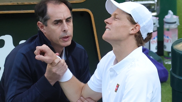 Jannik Sinner of Italy receives medical treatment during a medical time out against Grigor Dimitrov of Bulgaria during the Gentlemen's Singles fourth round match on day eight of The Championships Wimbledon 2025 at All England Lawn Tennis and Croquet Club