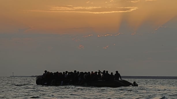 GRAVELINES, FRANCE - JULY 02: A small boat heads off in to the English Channel after picking up migrants at sunrise on July 02, 2025 in Gravelines, France. The pair were unsuccessful in boarding and made their way back to the shore to try another day. The boat had arrived through the fog, already ve