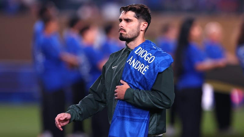 Pedro Neto carries a jersey bearing the names of Diogo and Andre Jota during the FIFA Club World Cup