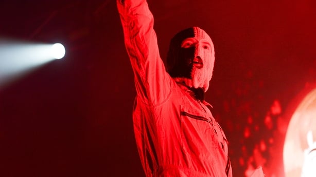 a person in a mask with his arms up