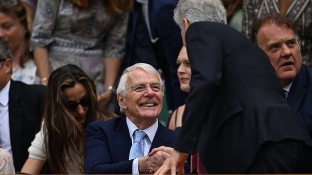 LONDON, ENGLAND - JULY 09: Former Prime Minister the Rt Hon Sir John Major interacts with guests in the royal box ahead of the Ladies' Singles quarter-final match between Mirra Andreeva and Belinda Bencic of Switzerland on day ten of The Championships Wimbledon 2025 at All England Lawn Tennis and Cr