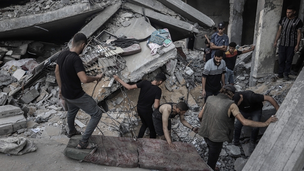 Palestinians inspect the damage caused by an Israeli airstrike on a residential block in the Al-Shati refugee camp in Gaza City, on Wednesday, July 9, 2025. President Donald Trump said he would meet again with Israeli Prime Minister Benjamin Netanyahu on Tuesday to further efforts to secure a ceasef