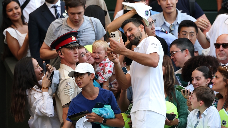 Novak Djokovic takes a selfie after his victory over Flavio Cobolli