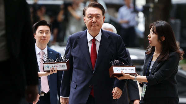South Korea's former impeached president Yoon Suk Yeol (C) arrives at a court to attend a hearing to review his arrest warrant requested by special prosecutors, in Seoul on July 9, 2025. South Korean prosecutors requested a new arrest warrant on July 6 to