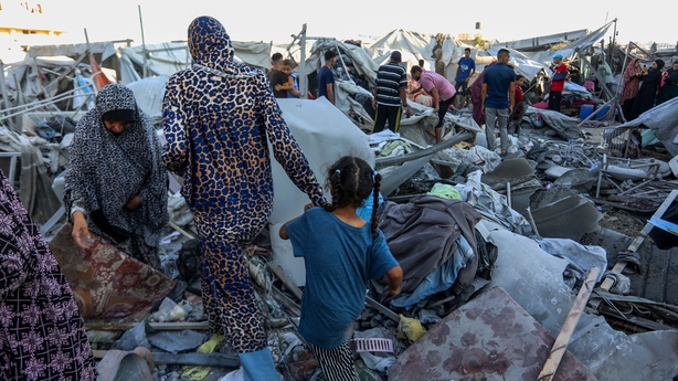 Gaza move through rubble in Khan Younis