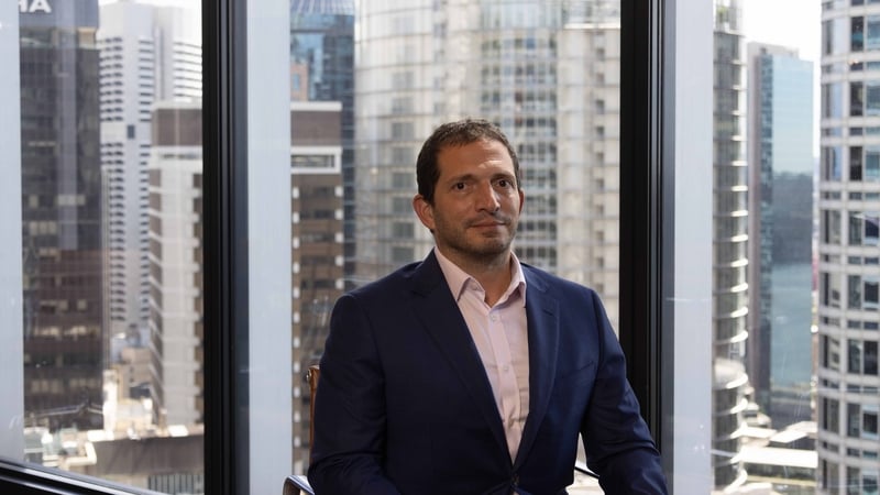 Matthew Biviano - Plenary executive sitting in a suit in a high-rise office
