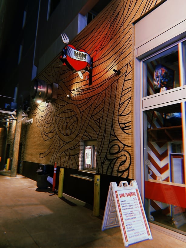 a building with a red and silver sign