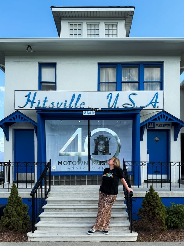 a person standing outside of Hitsville U.S.A.