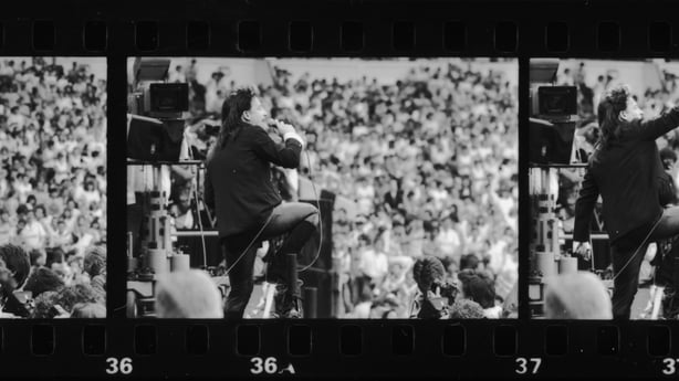 A series of three images of Irish singer Bono, during U2's performance at the Live Aid charity concert, Wembley Stadium, London, 13th July 1985. (Photo by Dave Hogan/Hulton Archive/Getty Images)