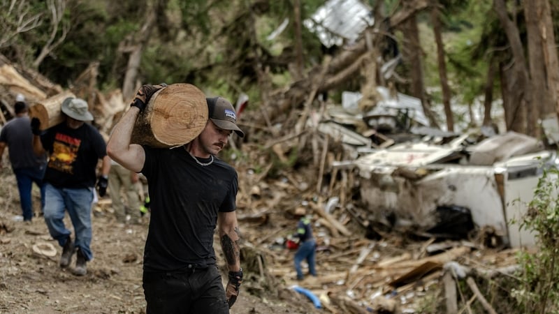 Search and recovery crews remove debris from the bank of the Guadalupe River in Center Point, Texas