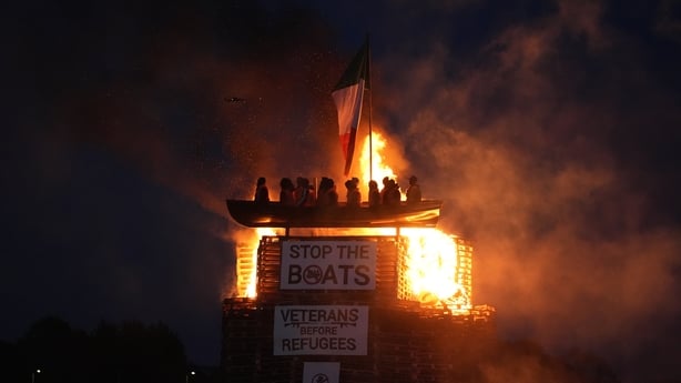 Effigies of migrants in a boat burn atop a bonfire at Moygashel, Co Tyrone