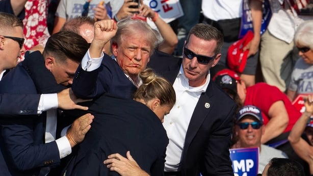 Donald Trump is rushed offstage by US Secret Service agents after being grazed by a bullet during a rally on 13 July 2024 in Butler, Pennsylvania