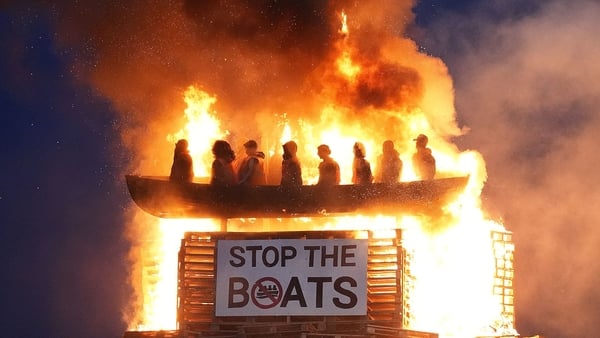 Effigies of migrants in a boat burn atop a bonfire at Moygashel, Co Tyrone