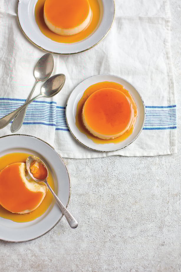 a plate of creme caramel dessert with spoons