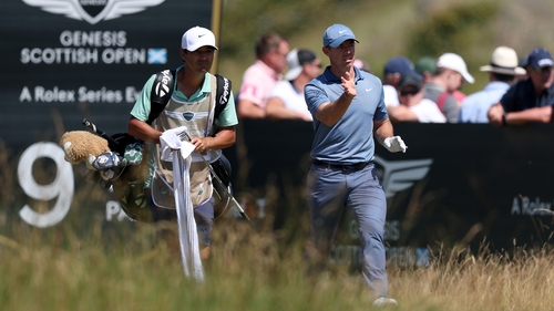 Rory McIlroy and caddie Harry Diamond walk from the ninth tee