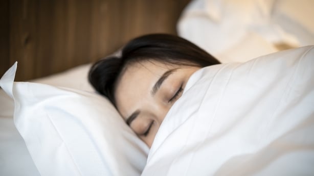 A young Asian woman is sleeping