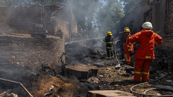 Ukrainian firefighters extinguish a fire in a horses' stable following Russian drones strike in Odesa