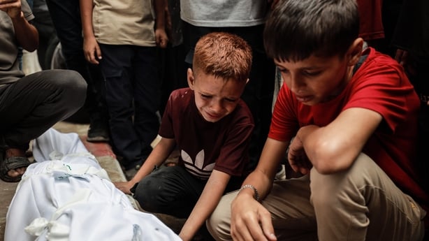 Relatives mourn after a loved one was killed in an israeli air strike on Gaza City