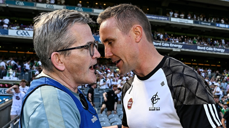 Limerick boss Jimmy Lee is consoled by Kildare manager Brian Flanagan