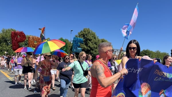People march with pride flags and rainbow paraphernalia at the annual Limerick pride parade