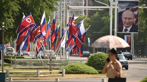 A portrait of Russian President Vladimir Putin is seen near national flags of North Korea and Russia in Pyongyang last year